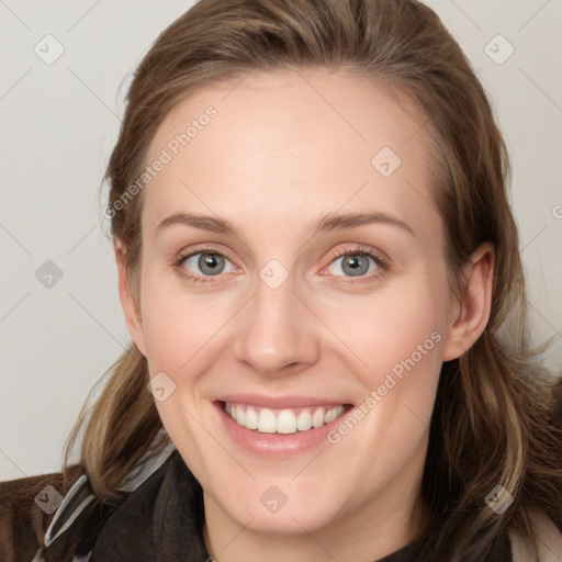 Joyful white young-adult female with long  brown hair and blue eyes