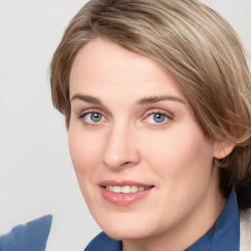 Joyful white young-adult female with medium  brown hair and blue eyes