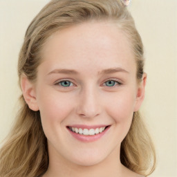 Joyful white young-adult female with long  brown hair and blue eyes