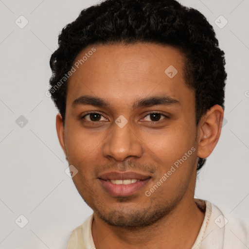 Joyful black young-adult male with short  brown hair and brown eyes