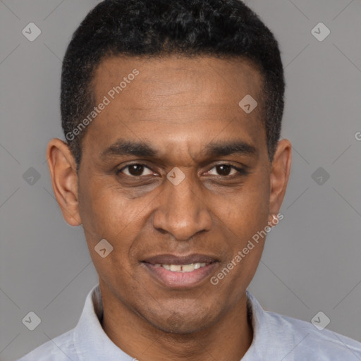 Joyful black adult male with short  black hair and brown eyes