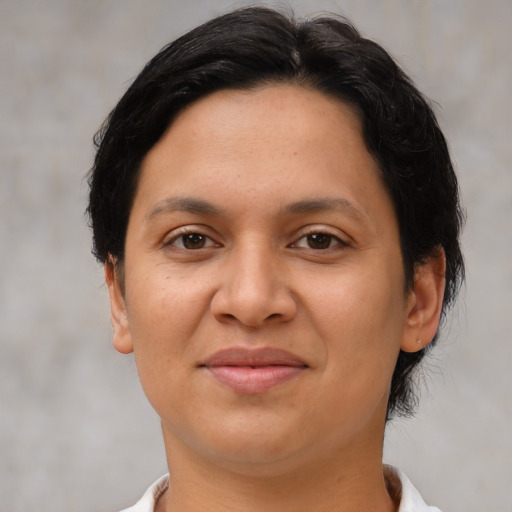 Joyful latino young-adult female with short  brown hair and brown eyes
