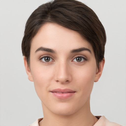 Joyful white young-adult female with short  brown hair and brown eyes