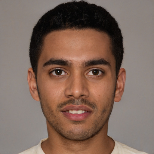 Joyful latino young-adult male with short  brown hair and brown eyes