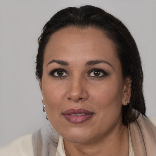 Joyful black adult female with medium  brown hair and brown eyes