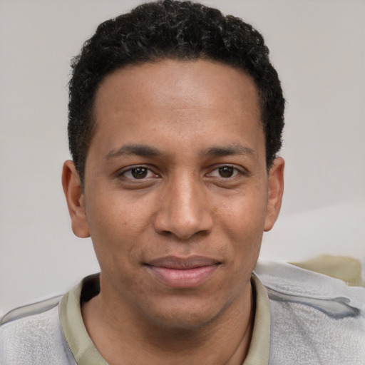 Joyful white young-adult male with short  black hair and brown eyes