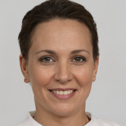 Joyful white adult female with short  brown hair and brown eyes