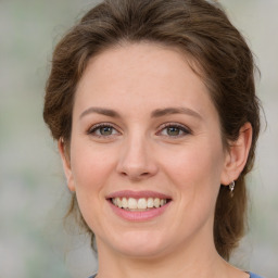 Joyful white young-adult female with medium  brown hair and green eyes