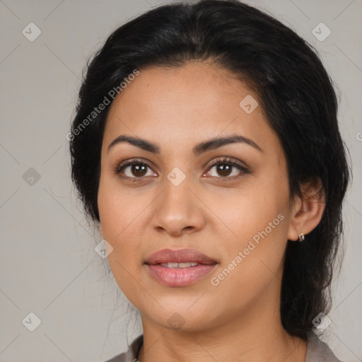 Joyful latino young-adult female with medium  brown hair and brown eyes