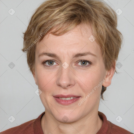 Joyful white adult female with medium  brown hair and blue eyes