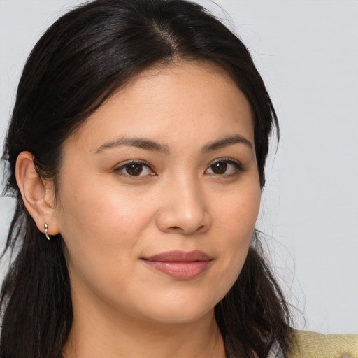 Joyful asian young-adult female with long  brown hair and brown eyes