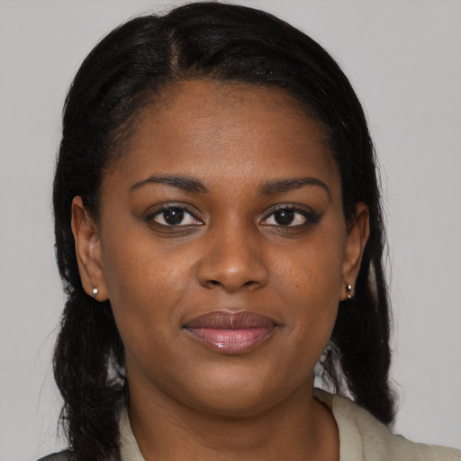 Joyful black young-adult female with long  brown hair and brown eyes