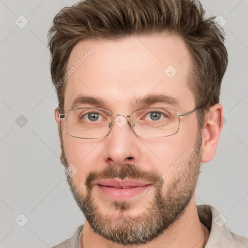 Joyful white adult male with short  brown hair and grey eyes