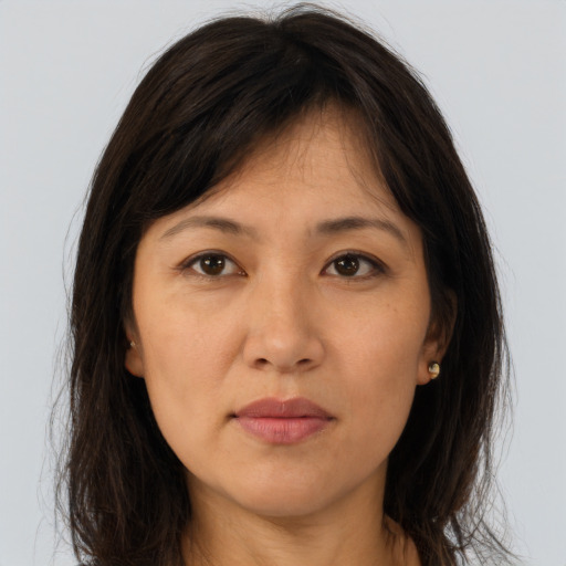 Joyful asian young-adult female with long  brown hair and brown eyes