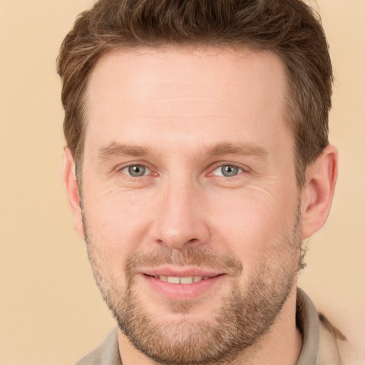 Joyful white adult male with short  brown hair and brown eyes