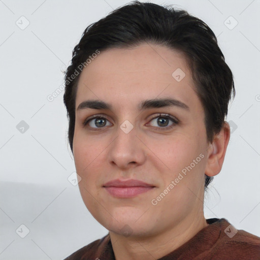 Joyful white young-adult female with short  brown hair and brown eyes