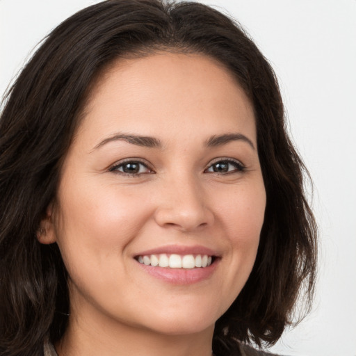 Joyful white young-adult female with long  brown hair and brown eyes