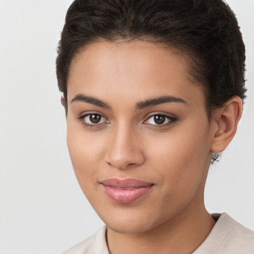 Joyful latino young-adult female with short  brown hair and brown eyes