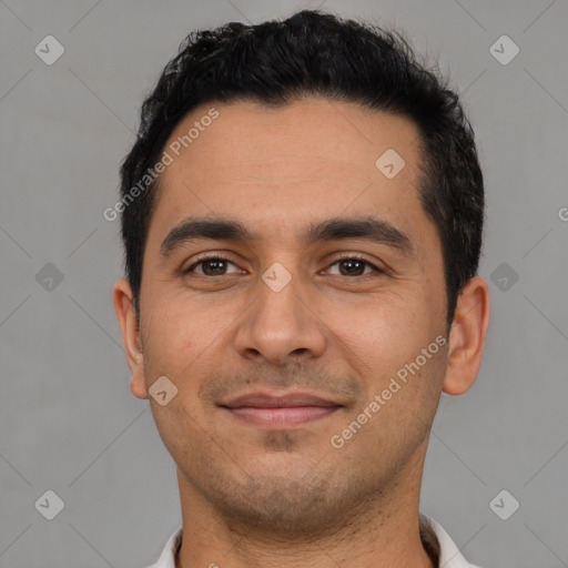 Joyful latino young-adult male with short  black hair and brown eyes