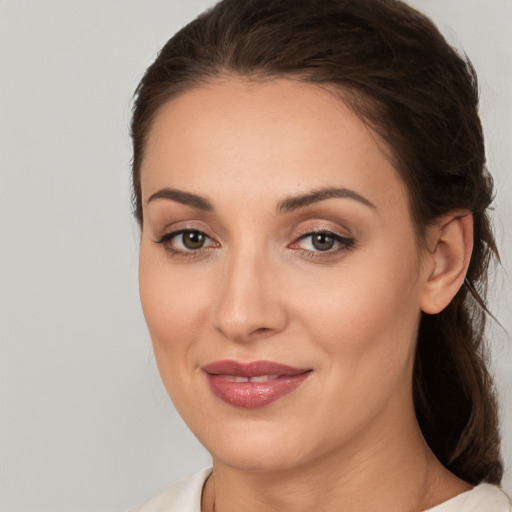 Joyful white young-adult female with medium  brown hair and brown eyes