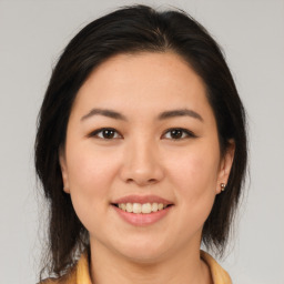 Joyful latino young-adult female with medium  brown hair and brown eyes