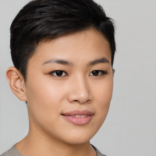Joyful asian young-adult female with short  brown hair and brown eyes