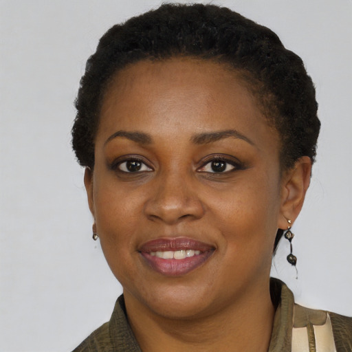 Joyful black young-adult female with short  black hair and brown eyes