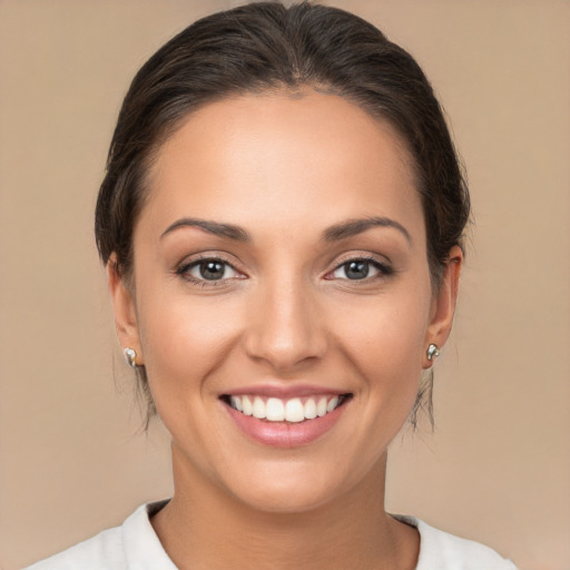 Joyful white young-adult female with medium  brown hair and brown eyes