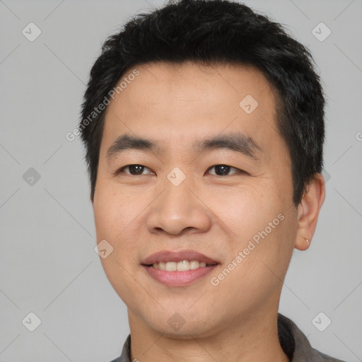 Joyful asian young-adult male with short  black hair and brown eyes