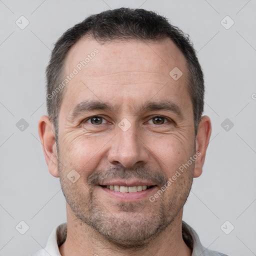 Joyful white adult male with short  brown hair and brown eyes