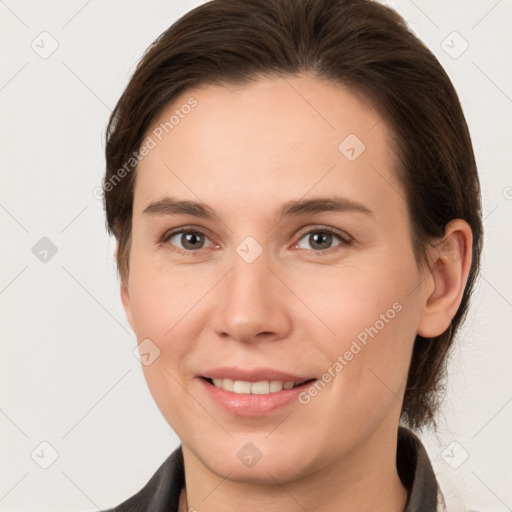 Joyful white young-adult female with medium  brown hair and grey eyes