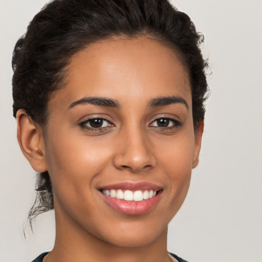 Joyful latino young-adult female with short  brown hair and brown eyes