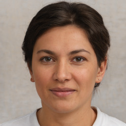 Joyful white adult female with short  brown hair and brown eyes