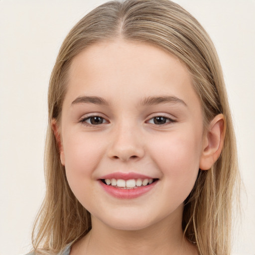 Joyful white child female with long  brown hair and brown eyes