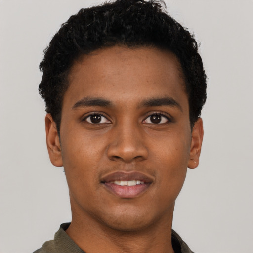 Joyful black young-adult male with short  black hair and brown eyes