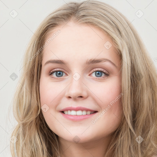 Joyful white young-adult female with long  brown hair and blue eyes