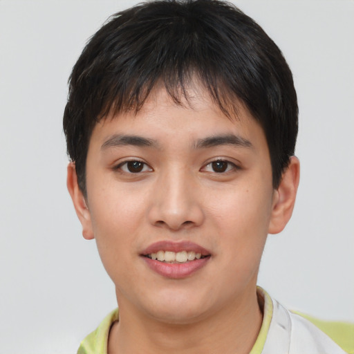 Joyful asian young-adult male with short  brown hair and brown eyes