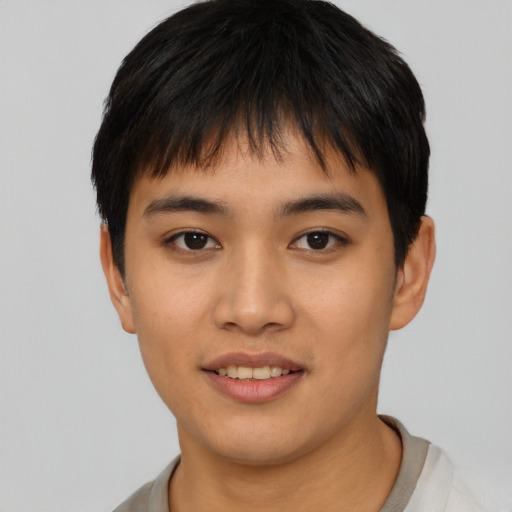 Joyful asian young-adult male with short  brown hair and brown eyes