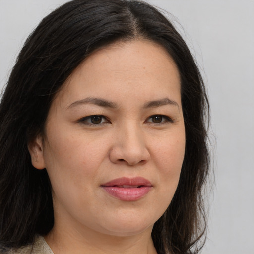 Joyful asian young-adult female with long  brown hair and brown eyes