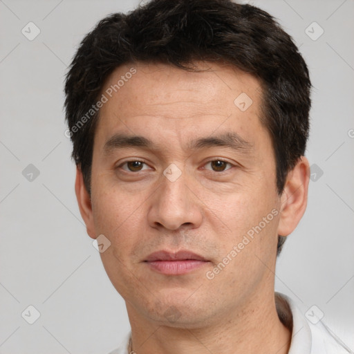 Joyful white adult male with short  black hair and brown eyes