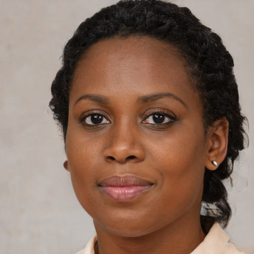 Joyful black young-adult female with medium  black hair and brown eyes