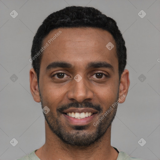 Joyful black young-adult male with short  black hair and brown eyes