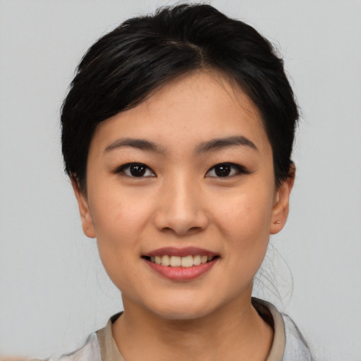 Joyful asian young-adult female with medium  black hair and brown eyes