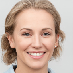 Joyful white young-adult female with medium  brown hair and blue eyes