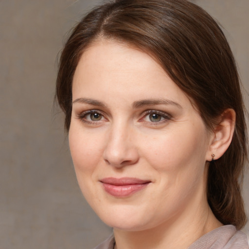 Joyful white young-adult female with medium  brown hair and brown eyes