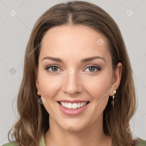 Joyful white young-adult female with long  brown hair and green eyes