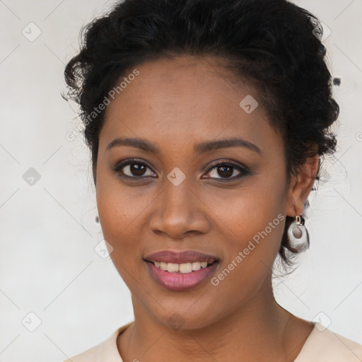 Joyful black young-adult female with long  brown hair and brown eyes