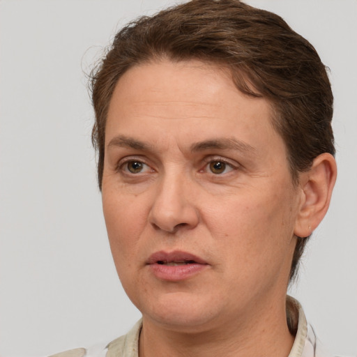 Joyful white adult female with short  brown hair and grey eyes