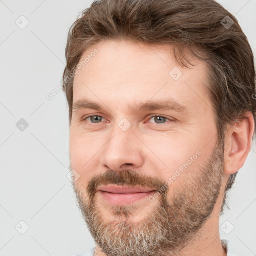 Joyful white adult male with short  brown hair and brown eyes