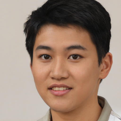 Joyful asian young-adult male with short  black hair and brown eyes